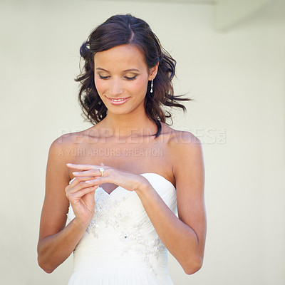 Buy stock photo A young bride looking at her wedding ring