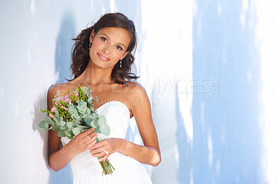 Buy stock photo A gorgeous bride standing outside with her bouquet