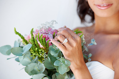 Buy stock photo Diamond, wedding ring and hands of bride with bouquet, flowers and pride for commitment, celebration or marriage. Bridal, aesthetic and woman closeup with engagement jewelry or floral arrangement