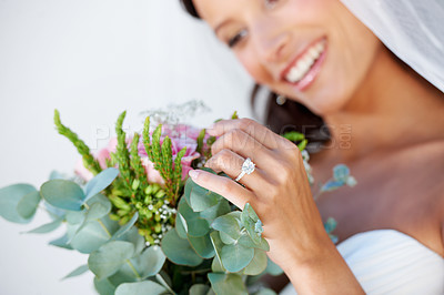 Buy stock photo Wedding, flowers and ring with woman and bouquet for beauty, celebration and engagement. Jewelry, smile and commitment with hands of bride at venue for marriage, ceremony and save the date event