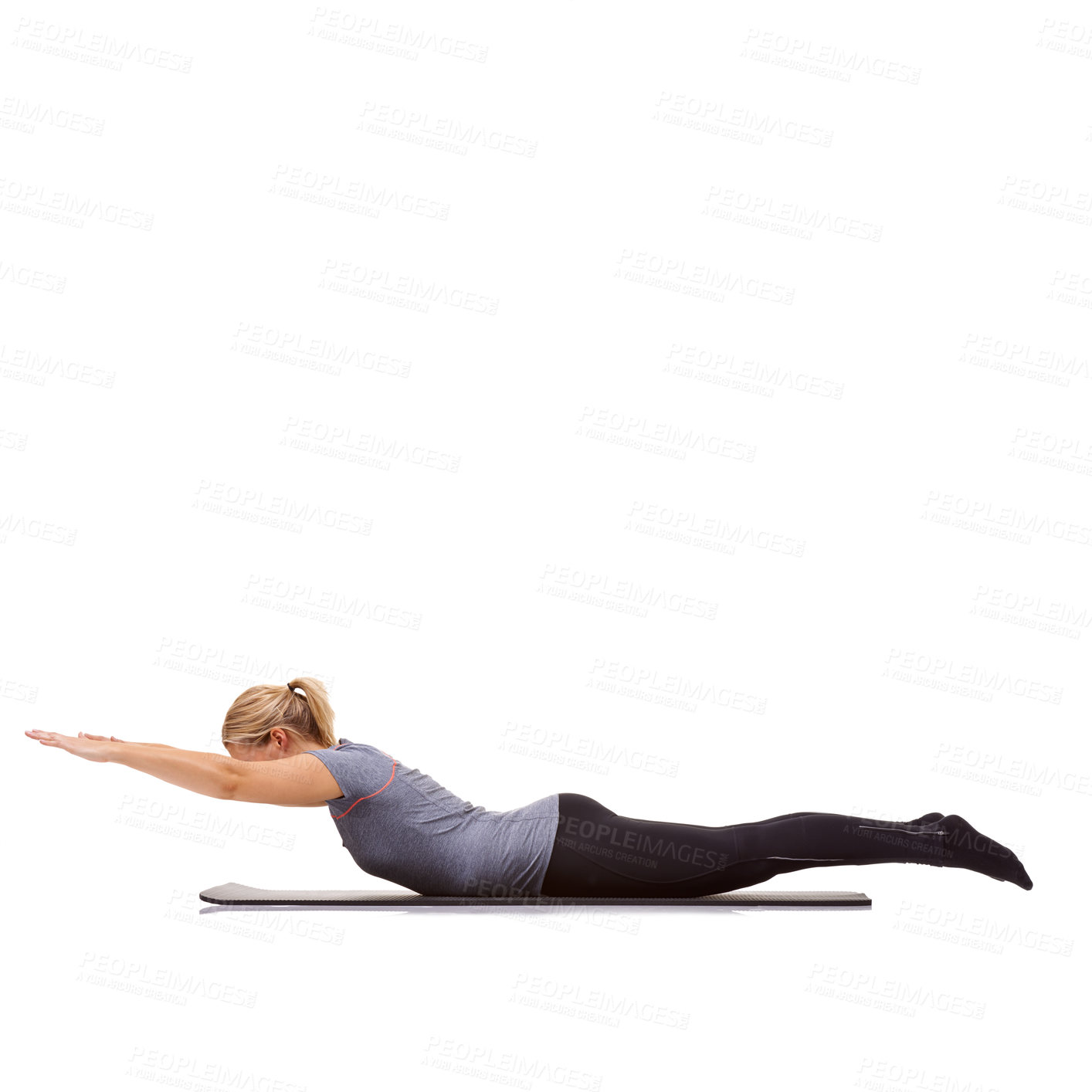 Buy stock photo A young woman exercising on a yoga mat