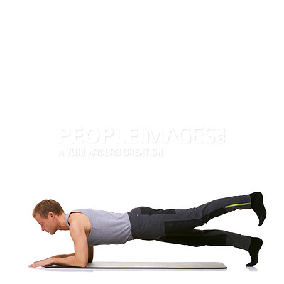 Buy stock photo A fit young man performing an exercise routine while isolated on a white background