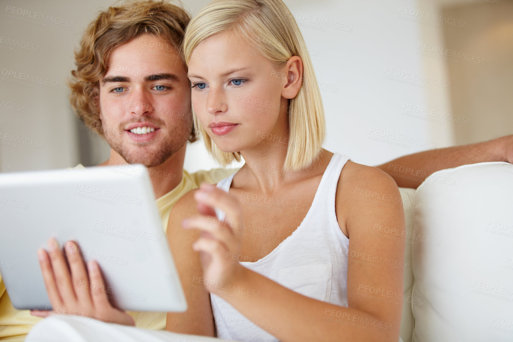 Buy stock photo Smile, tablet and young couple on sofa browsing on social media or internet at apartment. Relax, digital technology and happy man and woman from Australia scroll on website in living room at home.