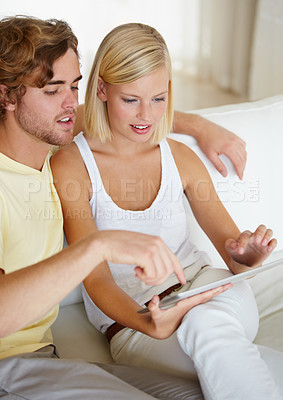 Buy stock photo Smile, tablet and young couple on sofa browsing on social media or internet at apartment. Happy, digital technology and man and woman from Australia relax and scroll on website in living room at home