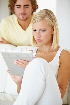 Buy stock photo Online, tablet and young couple on sofa browse on social media or internet at apartment. Read, digital technology and man and woman from Australia relax and scroll on website in living room at home.