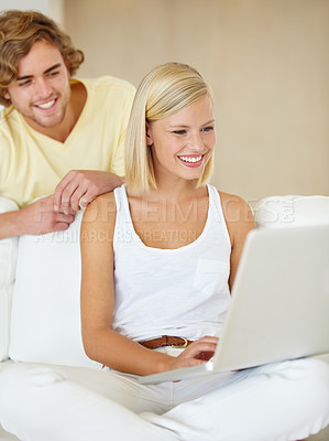 Buy stock photo Smile, laptop and young couple on sofa browsing on social media or the internet at apartment. Relax, technology and happy man and woman doing research on website with computer in living room at home.