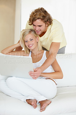 Buy stock photo Happy, laptop and young couple on sofa browsing on social media or the internet at apartment. Smile, technology and man and woman relax and researching on website with computer in living room at home