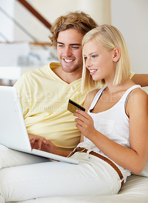 Buy stock photo Happy couple, credit card and computer on sofa for online shopping, loan and digital money at home. Young woman and man on laptop for internet banking, easy website payment or e commerce registration
