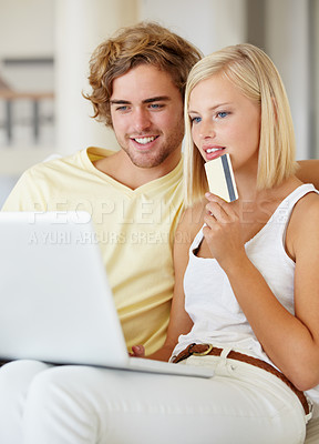 Buy stock photo Couple, credit card and thinking on laptop for online shopping, loan choice or digital money on sofa at home. Young woman and man on computer for internet banking, website payment or e commerce ideas
