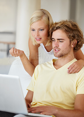 Buy stock photo Laptop, search and couple on a sofa with social media, movies or streaming at home together. Online shopping, internet and people in a living room checking ecommerce website deal for December sale