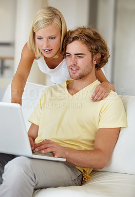 Buy stock photo Search, laptop and couple on a sofa with social media, movies or streaming at home together. Online shopping, internet and people in a living room checking ecommerce website deal for December sale