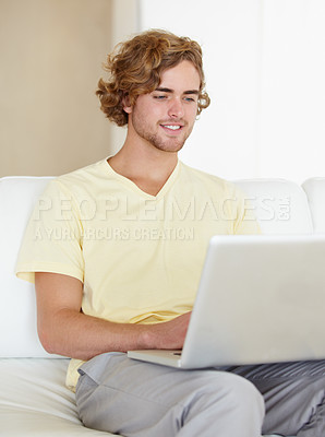 Buy stock photo Laptop, remote work and happy man on sofa for research, planning or web communication in his home. Tech, freelance and male entrepreneur online in living room with social media, search or streaming 