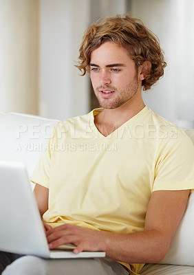 Buy stock photo Laptop, remote work and man on a sofa for research, planning or web communication in his home. Tech, freelance and male entrepreneur online in a living room with social media, search or streaming 