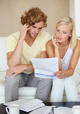 Buy stock photo Couple, stress for bills and thinking of documents on sofa for debt, financial planning or budget risk and worry at home. Confused woman and man with headache for loan, bankruptcy or mortgage letter