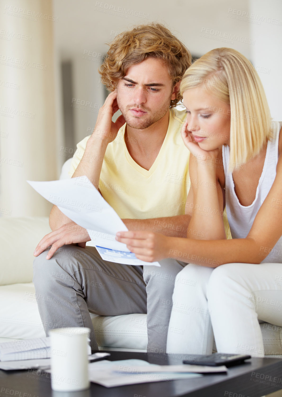 Buy stock photo Couple, confused for bills and reading documents on sofa with debt, financial planning or budget risk and stress at home. Serious man and woman thinking of loan, house expenses or mortgage paperwork