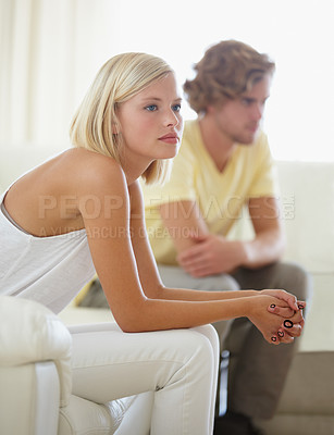 Buy stock photo Fight, divorce and couple on sofa with stress, anxiety or cheating depression in their home. Marriage, crisis and frustrated woman overthinking in living room with commitment, doubt or liar conflict