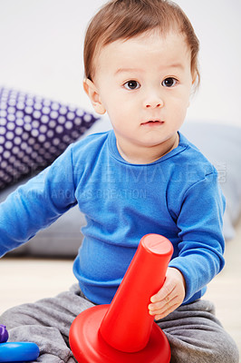 Buy stock photo Baby, toys and playing on carpet in home or development, learning or education. Boy, kid and floor for game in lounge or puzzle progress or cognitive interest for coordination, support or sensory fun