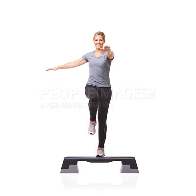 Buy stock photo A smiling young woman doing aerobics on an aerobic step against a white background