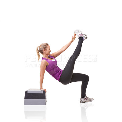 Buy stock photo A smiling young woman doing aerobics on an aerobic step isolated against a white background