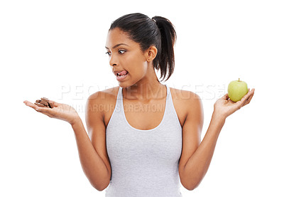 Buy stock photo Woman, apple and chocolate in studio with diet risk, temptation and cheat day with healthy food choice or sugar in studio. Person with sweets versus green fruit in palm or detox on a white background