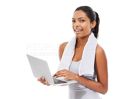 Buy stock photo A young woman in gym clothes working on a laptop