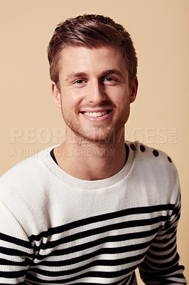 Buy stock photo Fashion, confidence and portrait of happy man on beige background in trendy, stylish and casual clothes. Smile, attractive and person in stripe for positive attitude, pride and style in studio