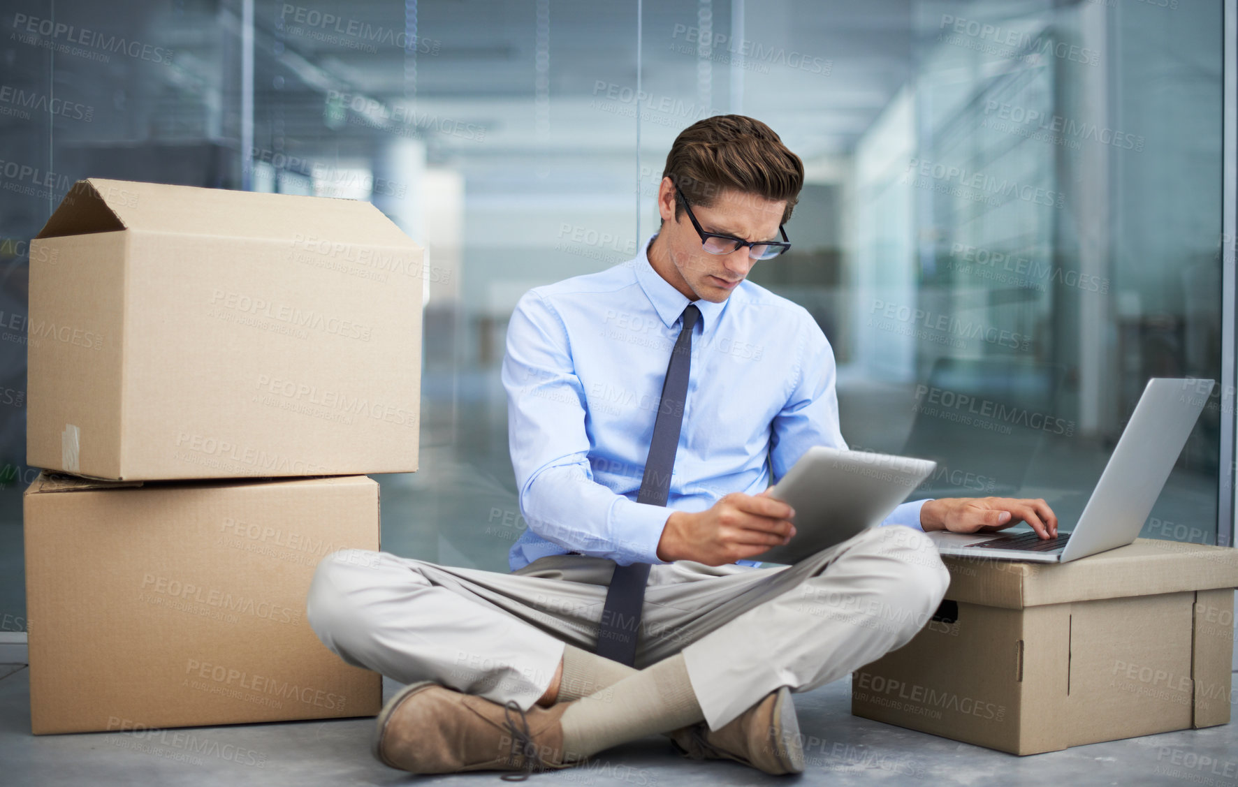 Buy stock photo Tablet, office laptop and man with moving boxes, business data and reading report, statistics analysis or online news. Workplace relocation, cardboard box and male businessman typing research project