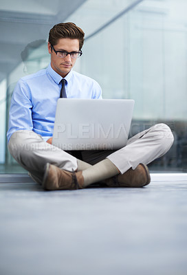 Buy stock photo Laptop, office floor and business man typing financial report, statistics analysis or search online, internet or website. Research, company workplace and male businessman, banker or person working