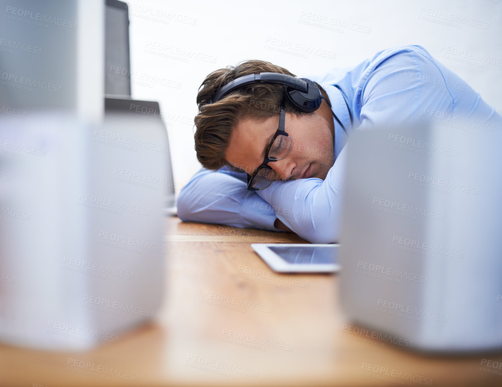 Buy stock photo Office desk, sleep and business man tired after working on project, software system or coding tech, script or programming. Programmer burnout, developer fatigue and sleeping person listening to music