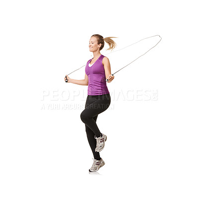 Buy stock photo An attractive young woman working up a sweat with the skipping rope