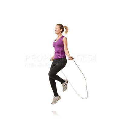 Buy stock photo An attractive young woman skipping against a white background