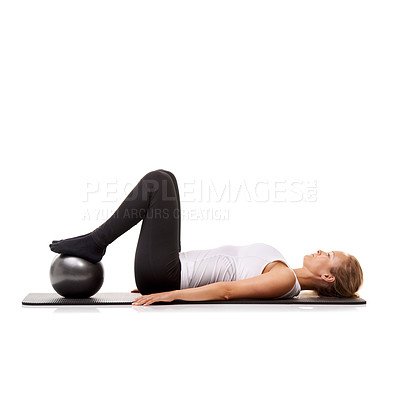 Buy stock photo Yoga, exercise and woman on floor with ball for pilates, wellness care and health in studio. Gym, training and girl on mat with workout, lying and muscle fitness isolated on white background.