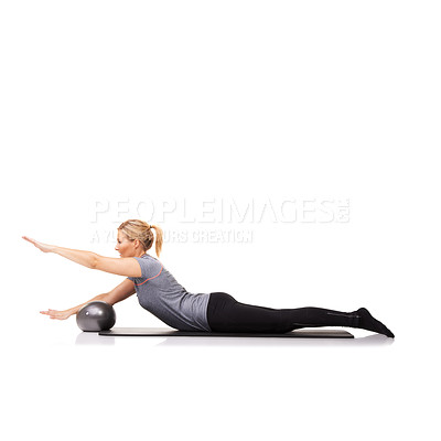 Buy stock photo A young woman using an exercise ball while lying down - isolated