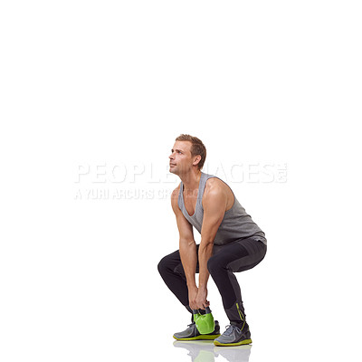 Buy stock photo A handsome young man working out with a kettlebell while isolated on a white background