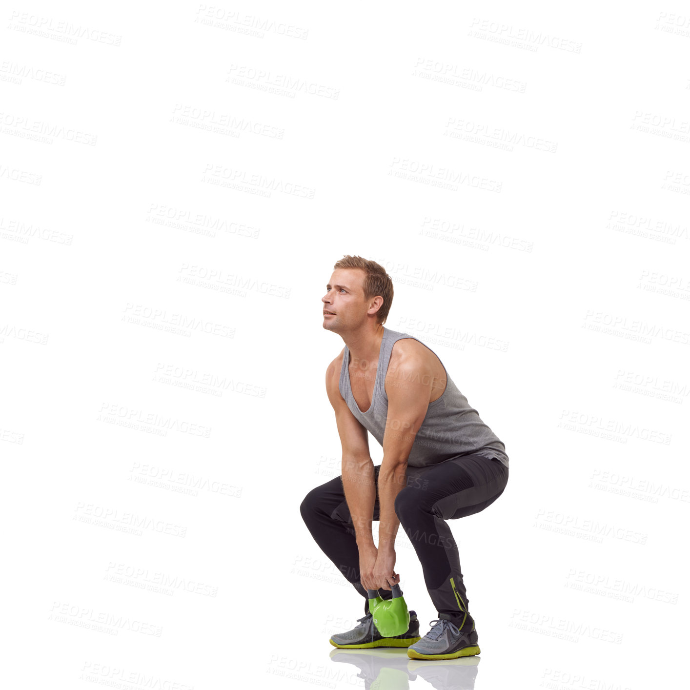 Buy stock photo A handsome young man working out with a kettlebell while isolated on a white background