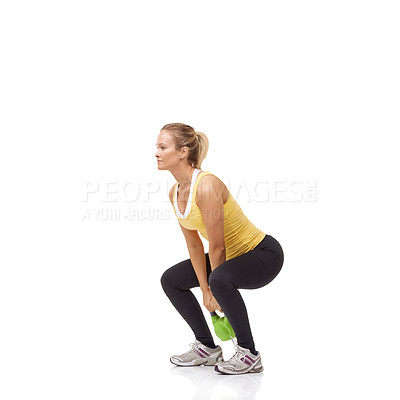 Buy stock photo A beautiful blonde woman performing a two-handed kettlebell swing