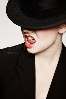 Buy stock photo An expressive young woman with red lips and a hat
