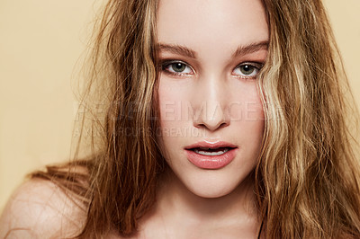 Buy stock photo Woman, face and beauty with skin and hair, natural cosmetics with dermatology shine on beige background. Clean makeup, portrait and haircare with highlights, skincare and young model in studio
