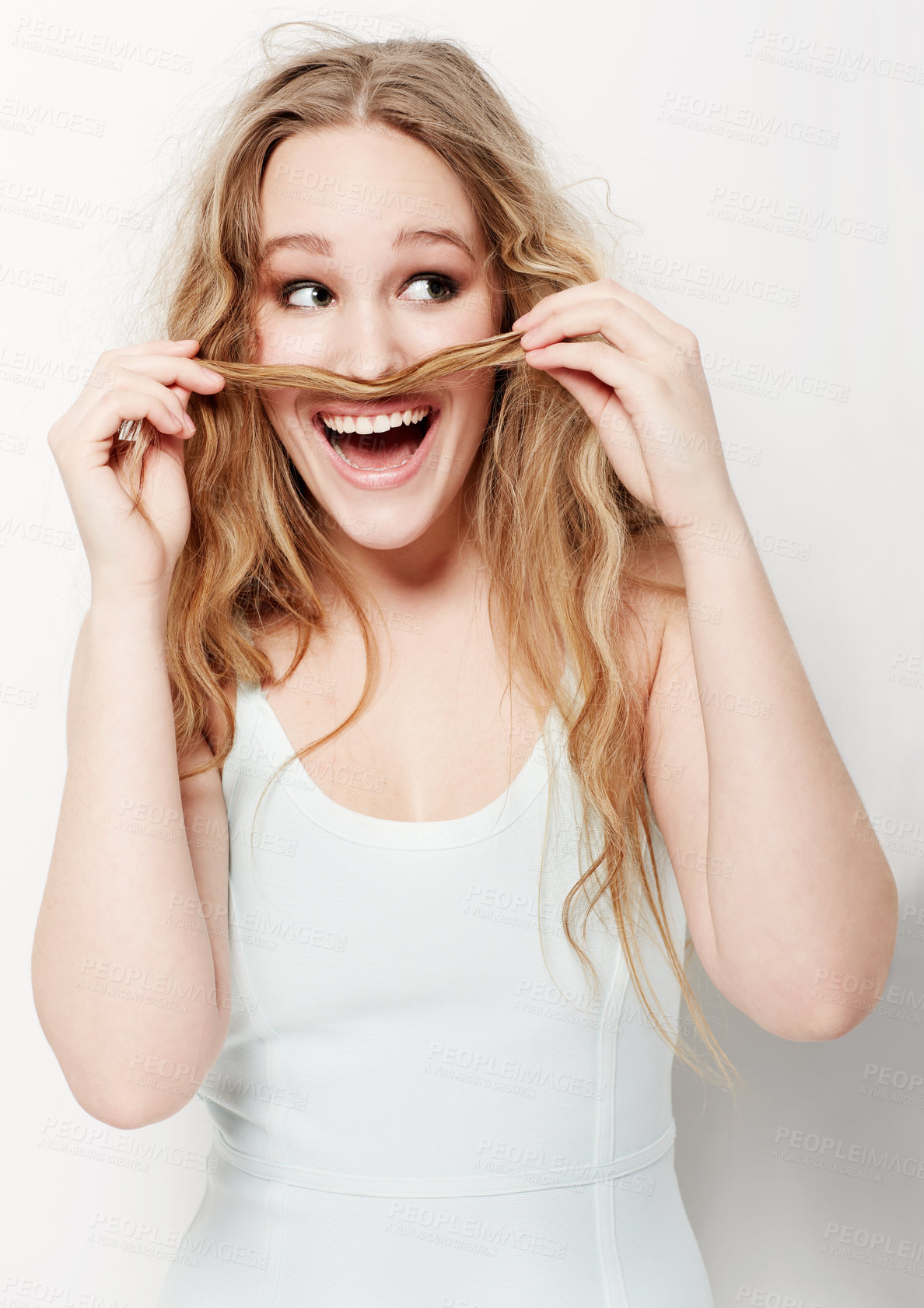 Buy stock photo Playful young woman making a mustache with her hair against a white background