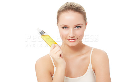 Buy stock photo A pretty young woman holding a bottle of perfume while isolated on a white background