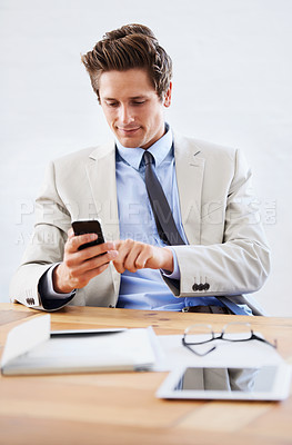 Buy stock photo Businessman, phone and networking or texting in office, connection and contact for company. Male person, professional and communication or mobile application, technology and smile for discussion