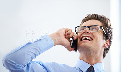 Buy stock photo An excited young businessman chatting on his cellphone call with a smile