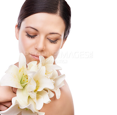 Buy stock photo Flower, beauty and woman in studio for makeup, wellness or eco friendly cosmetics on white background space. Lily, plant or face of model with glowing skin, dermatology or floral cosmetology results