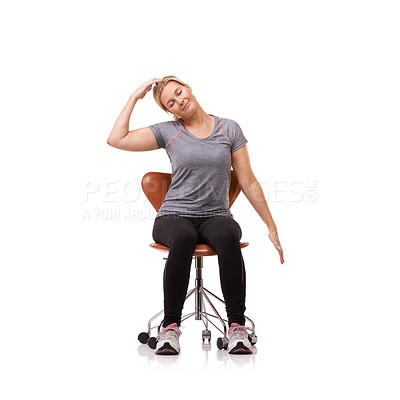 Buy stock photo Shot of a sporty woman doing stretches on a chair