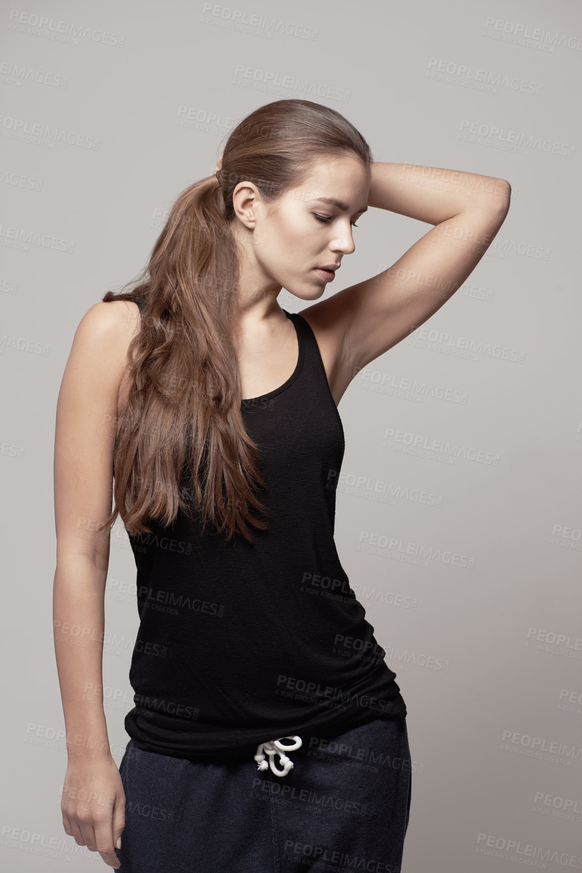 Buy stock photo Fashion, casual and woman in a studio with fitness apparel, outfit or clothes and confidence, isolated on grey studio background. Pose, natural beauty and female model with cool style or athleisure