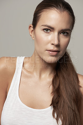 Buy stock photo Serious woman, portrait and natural beauty in skincare or facial cosmetics against grey studio background. Isolated female person, face or model in cosmetic haircare in active sportswear on backdrop