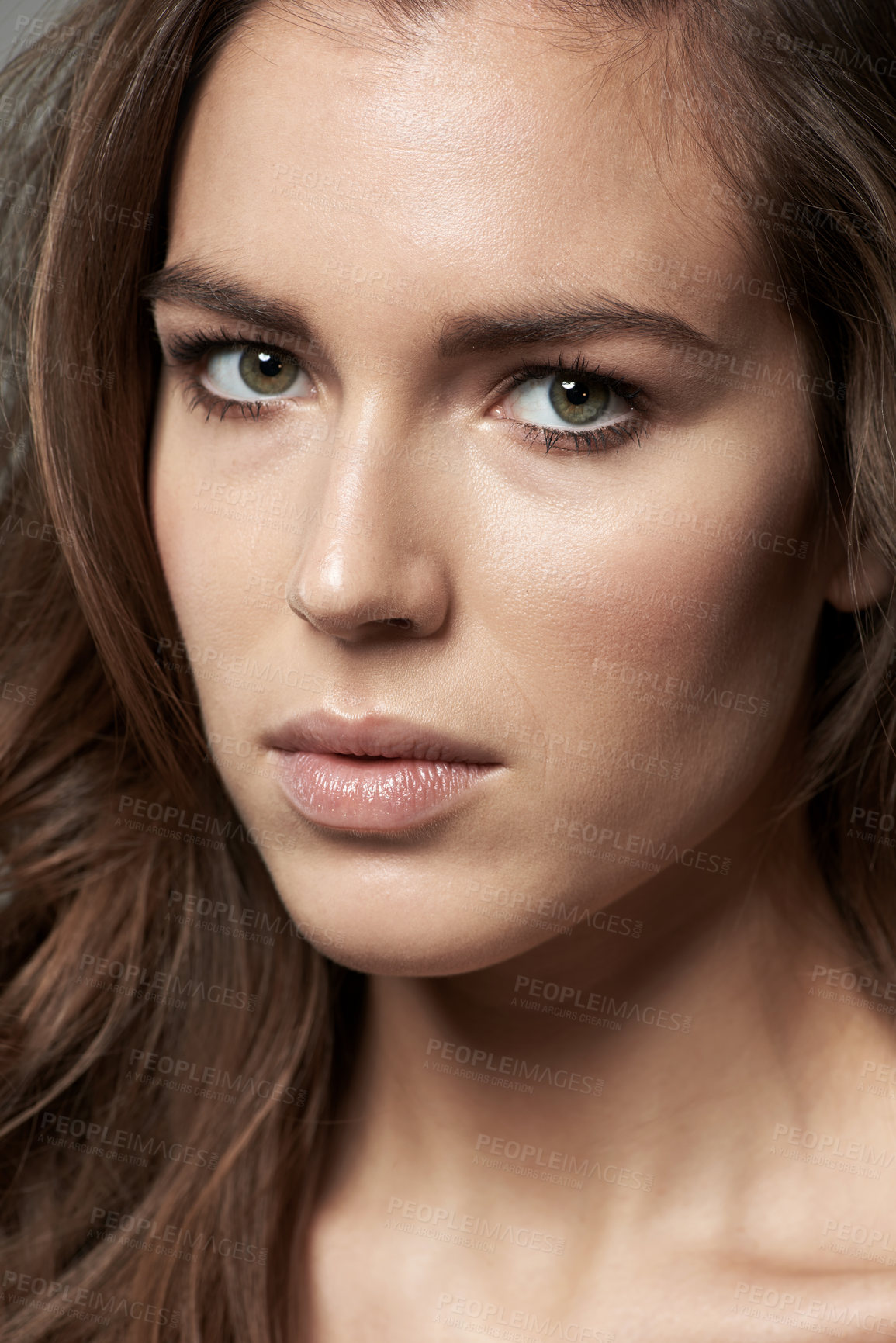 Buy stock photo Cropped shot of a beautiful young woman against a gray background