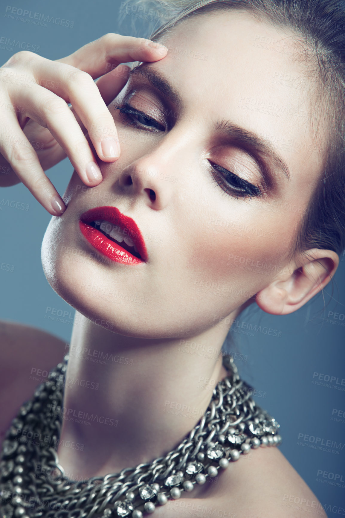 Buy stock photo Closeup shot of a gorgeous young woman wearing bright red lipstick and an elegant necklace