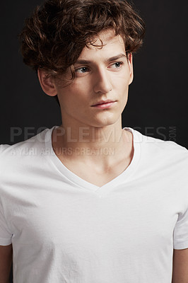 Buy stock photo A handsome young man with elegant facial features looking away thoughtfully