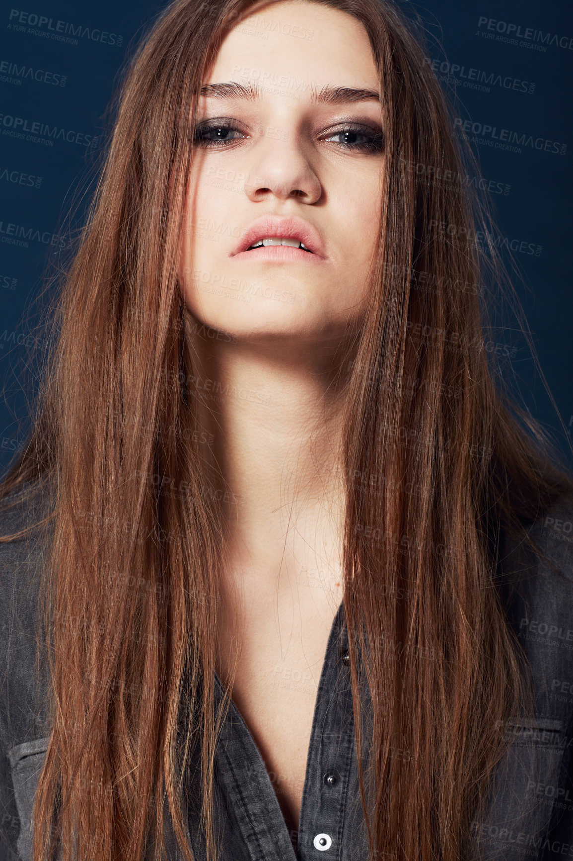 Buy stock photo A stunning model with a rebellious attitude staring you down in studio